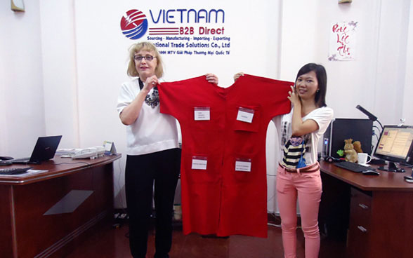 Entrepreneur Jeanne Mattick (USA) with Nhung Nguyen of Vietnam B2B Direct displaying the prototype of Ms. Mattick’s innovative Institutional Hospital Gown, currently being sourced and developed in Vietnam.