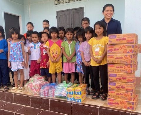 vietnam orphanages, Children walking together in a rural village in Central Vietnam, View of a small community in Central Vietnam, aregivers interacting with children at an orphanage in Central Vietnam, oung children receiving daily care and support at a local orphanage, Volunteers helping children with schoolwork in Central Vietnam,